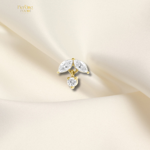 Goudkleurige threadless top van nikkelvrij staal met marquise-geslepen zirconia hanger. Luxe en glanzend design, geschikt voor diverse piercings.